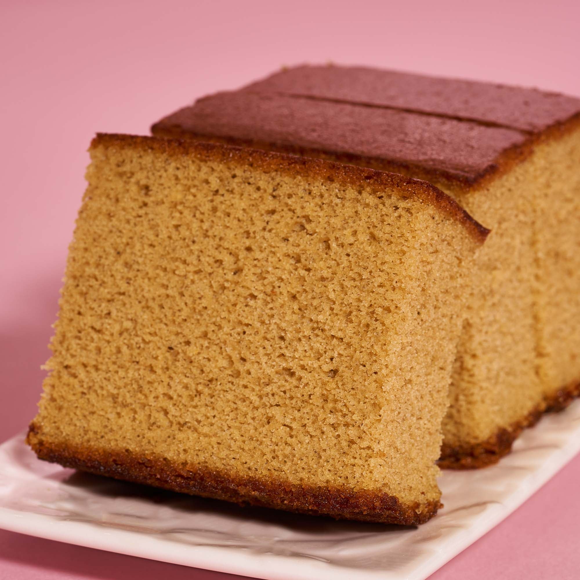 Castella kasutera - Beautiful delicious Japanese sliced sponge cake food on  white plate over rustic white wooden table, close up, copy space design  concept. 10287718 Stock Photo at Vecteezy